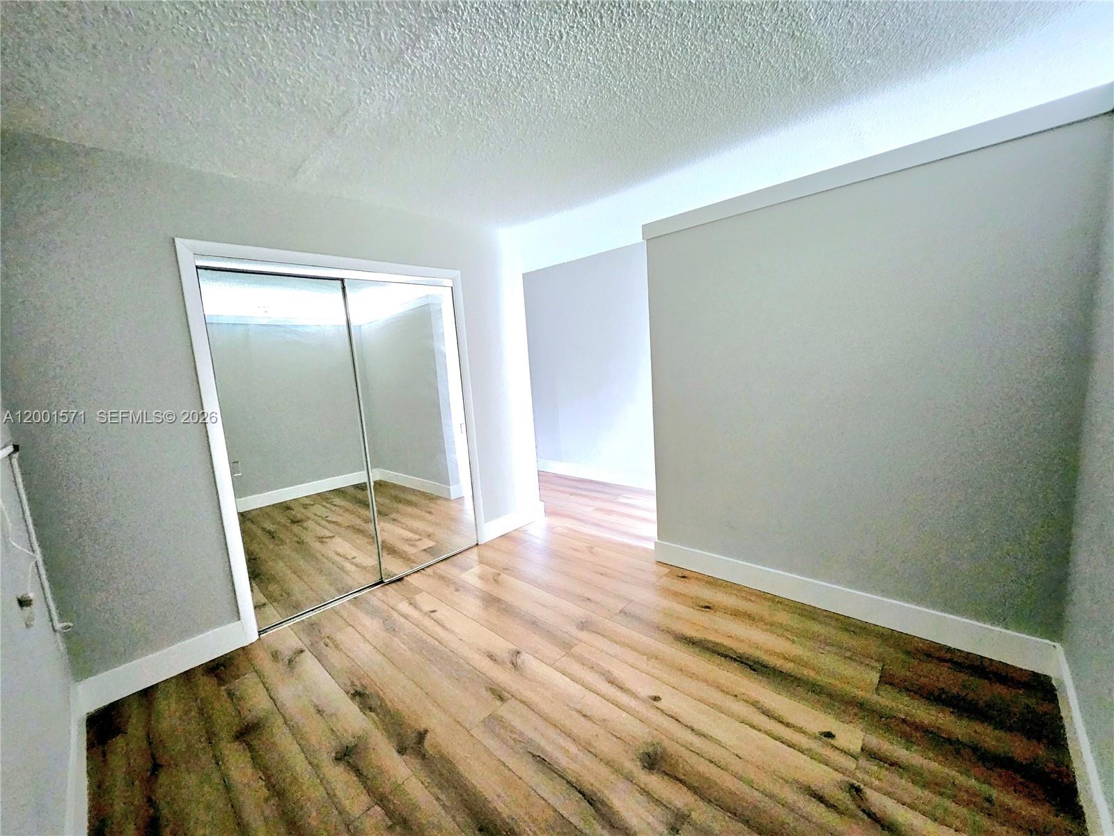 335 Southwest 20th Street, Unit 8 Fort Lauderdale, FL 33315 - Photo 7 of 11 a view of room with wooden floor