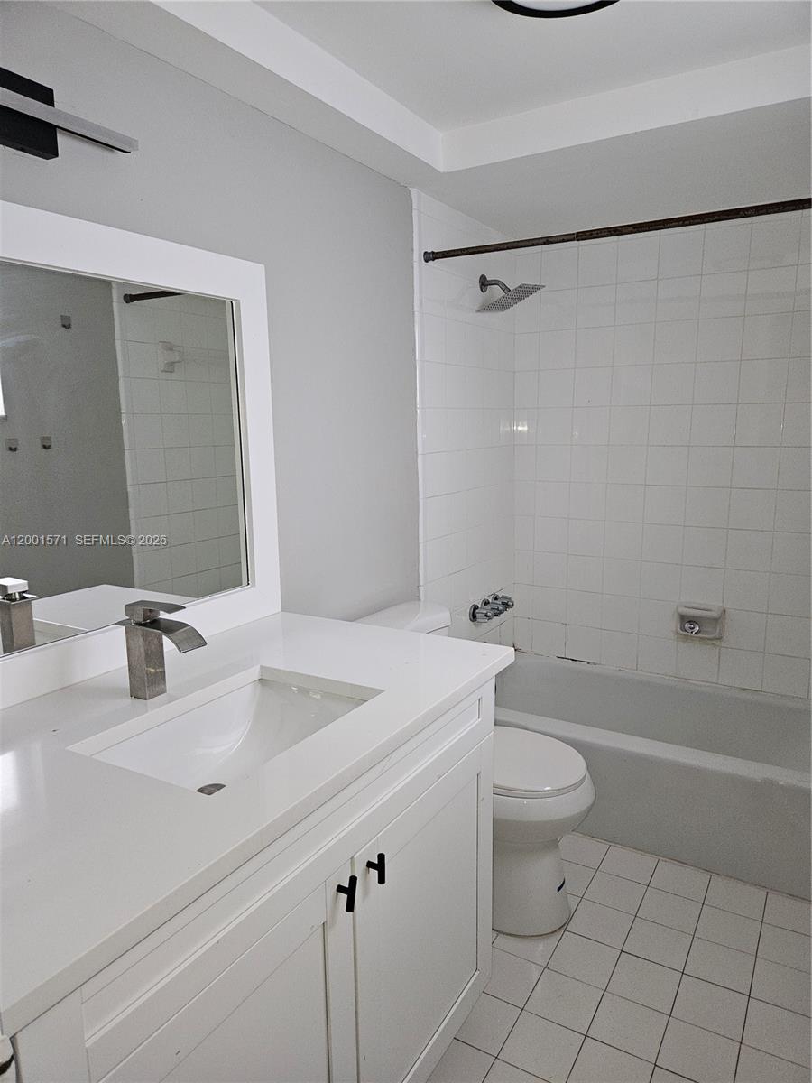 335 Southwest 20th Street, Unit 8 Fort Lauderdale, FL 33315 - Photo 9 of 11 a bathroom with a sink a toilet and a mirror