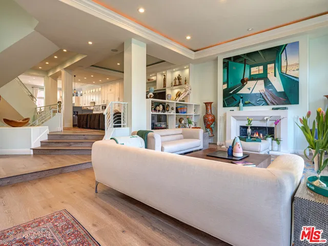 a living room with fireplace furniture and a flat screen tv