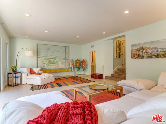 a living room with furniture a rug and a flat screen tv