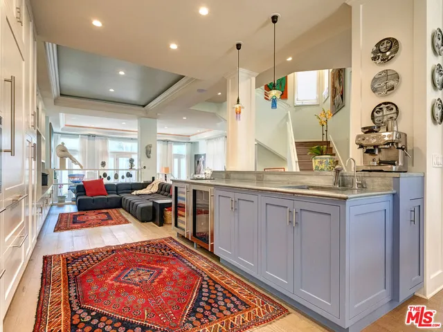 a kitchen that has a lot of cabinets in it and wooden floors