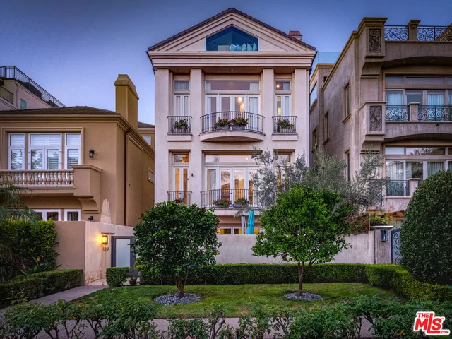 a front view of a residential apartment building with a yard