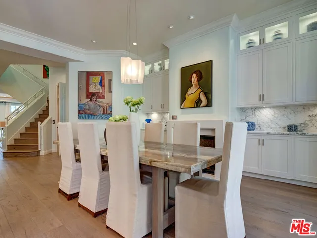 a living room with lots of furniture and kitchen view
