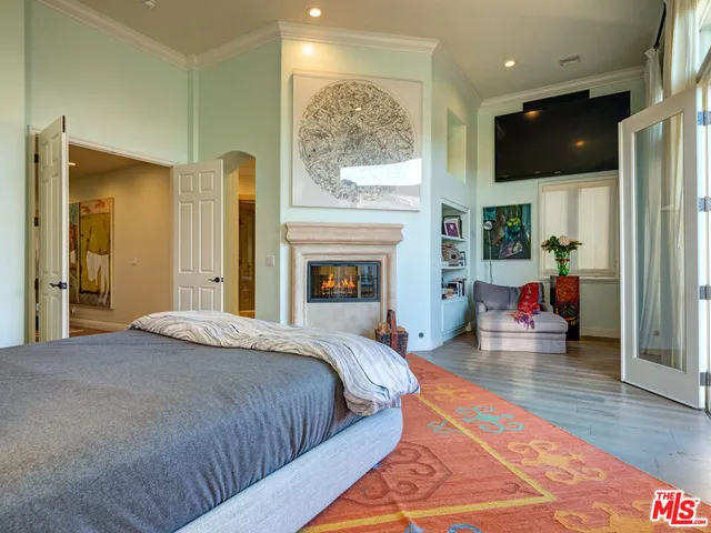 a bedroom with furniture and a book shelf