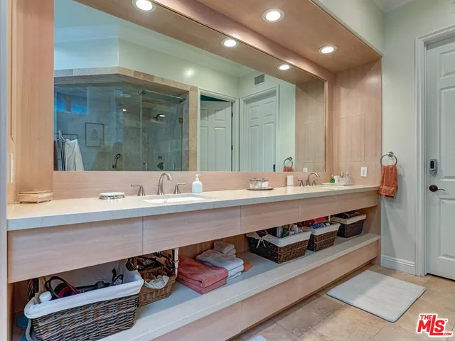 a bathroom with a shower sink and mirror