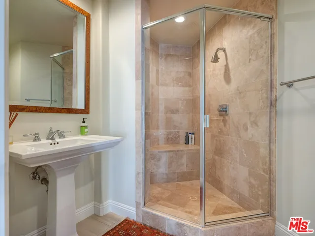 a living room with furniture a rug and a bookshelf
