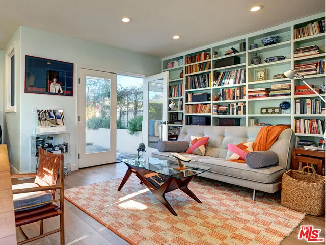 a bedroom with a bed and a large window with outer view