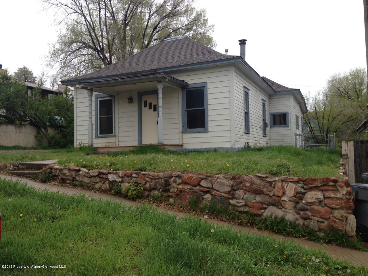 329 East 4th Street Rifle, CO 81650 - Photo 1 of 7 a front view of a house with a garden