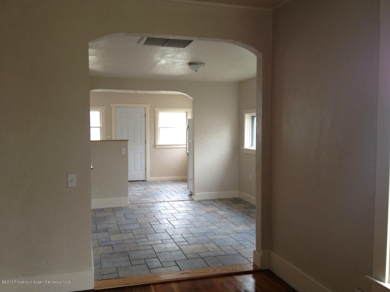 329 East 4th Street Rifle, CO 81650 - Photo 4 of 7 an empty room that has a mirror in it