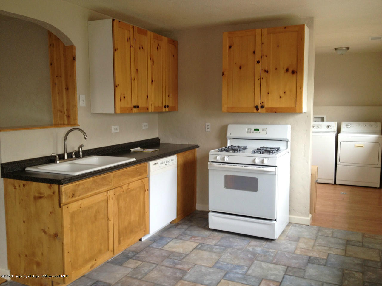 329 East 4th Street Rifle, CO 81650 - Photo 5 of 7 a kitchen with a sink stove and cabinets