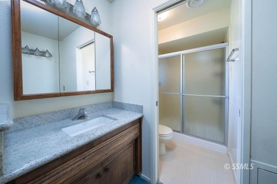 736 Sherri Street Ridgecrest, CA 93555 - Photo 13 of 42 a bathroom with a granite countertop sink and a mirror