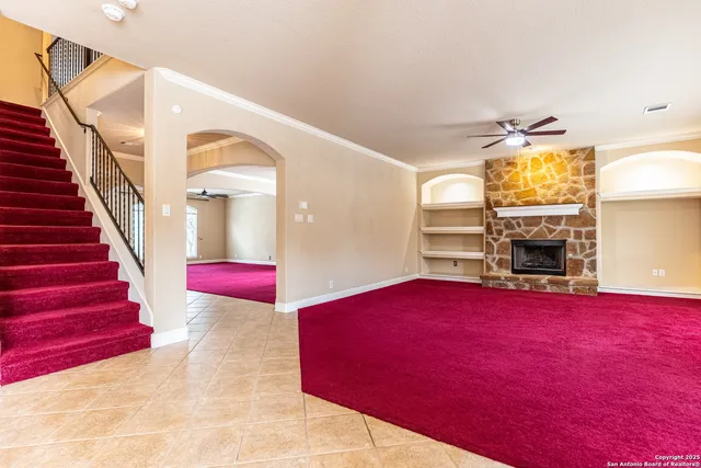 a view of a livingroom with furniture a fire place and windows