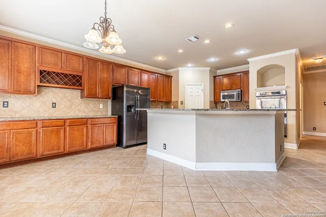 a kitchen with stainless steel appliances a refrigerator sink and cabinets