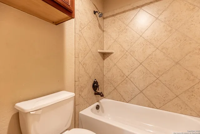 a bathroom with a bathtub and shower