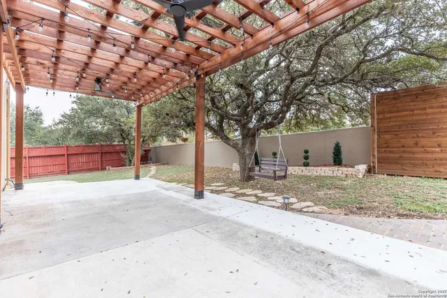 a view of a house with backyard and tree s