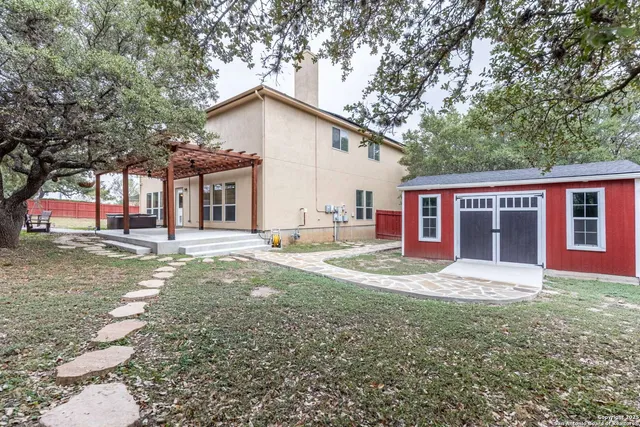 a view of a house with backyard and sitting area