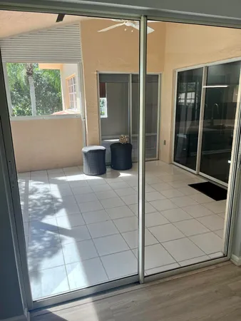 a view of a room with a window and wooden floor
