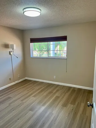 an empty room with wooden floor and closet