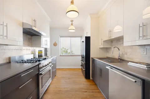 a kitchen with stainless steel appliances a sink stove and cabinets