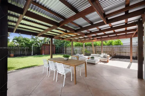 a view of a backyard with sitting area furniture and garden