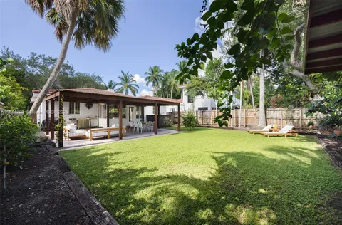 a front view of a house with garden and porch