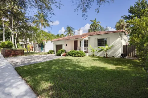 a front view of house with yard and green space