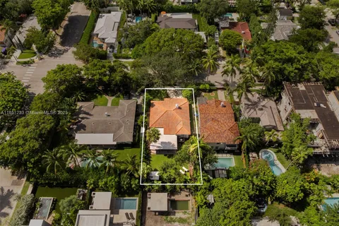 an aerial view of a house with a yard and lake view