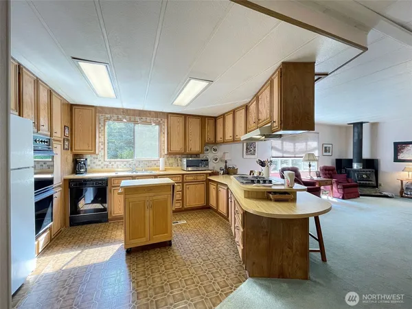 a kitchen with a sink a stove and cabinets