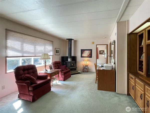 a living room with furniture a large window and a flat screen tv