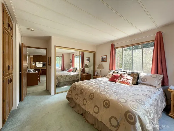 a bedroom with a bed and a large window
