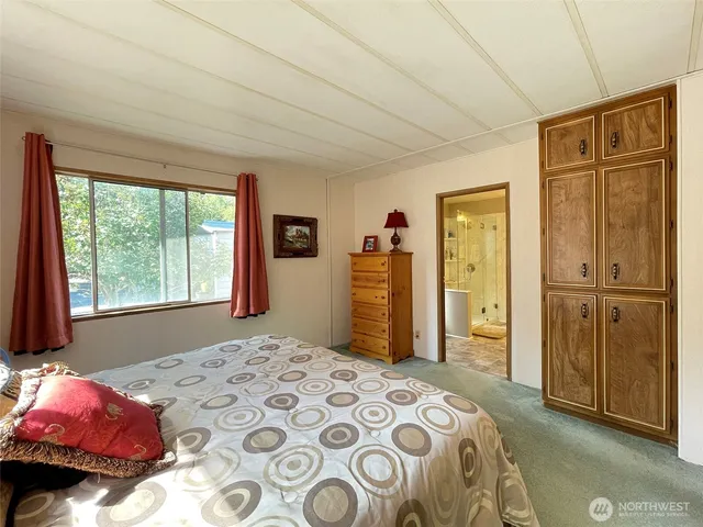 a bedroom with a bed and a dresser