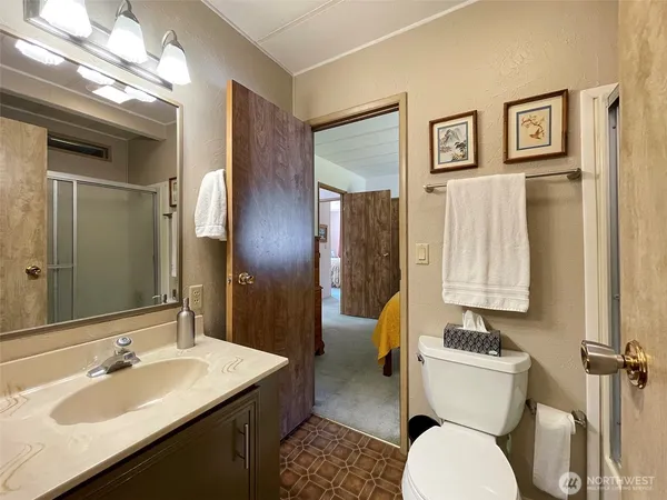 a bathroom with a toilet sink and mirror