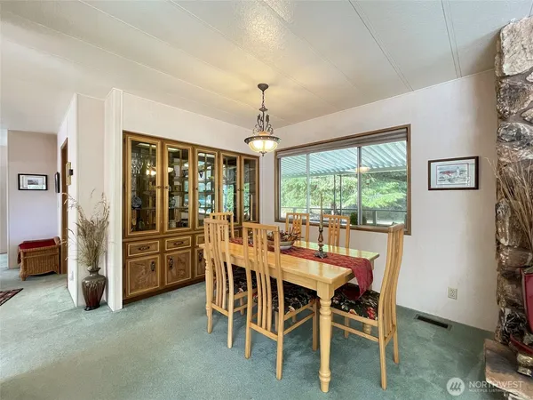 a view of a dining room with furniture window and outside view