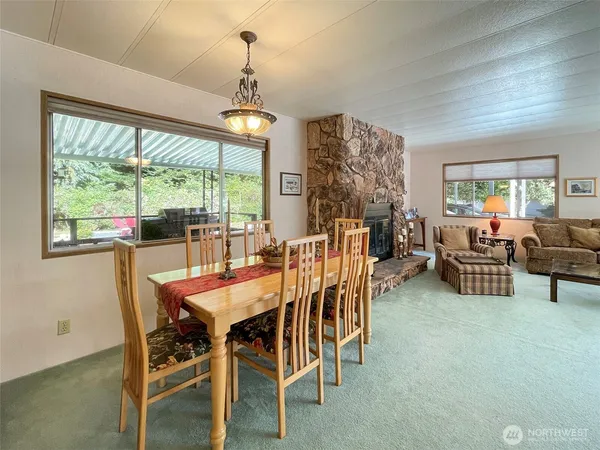 a dining room with furniture a chandelier and window