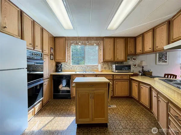 a kitchen with a stove sink and a microwave