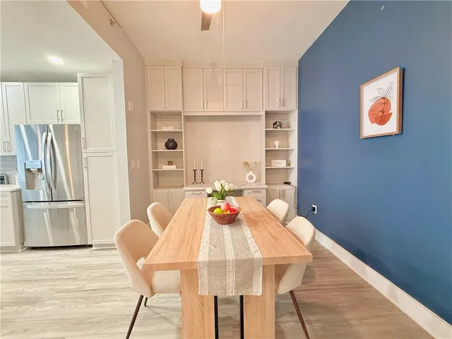 a view of a dining room with furniture and a refrigerator