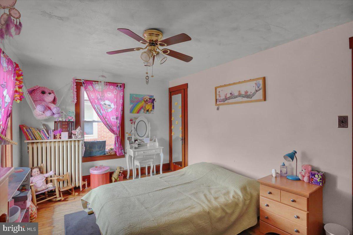 136 West Elm Street Reading, PA 19607 - Photo 12 of 23 a bedroom with a bed and a chandelier