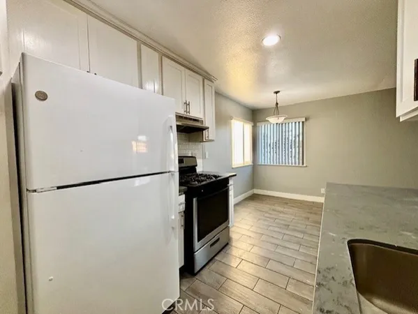 a white refrigerator freezer sitting in a kitchen