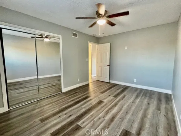 a view of an empty room and wooden floor