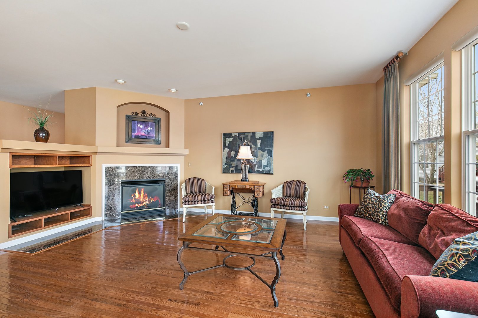 5876 Leeds Road Hoffman Estates, IL 60192 - Photo 15 of 37 a living room with furniture a large window and a fireplace