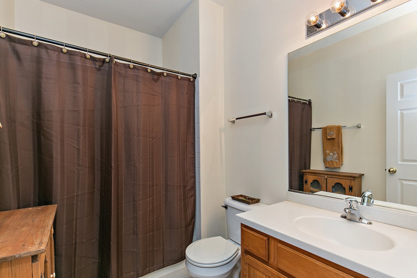 5876 Leeds Road Hoffman Estates, IL 60192 - Photo 20 of 37 a bathroom with a sink a toilet a mirror and shower curtain