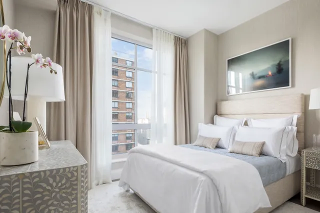 a bathroom with a double vanity sink a mirror and a bathtub