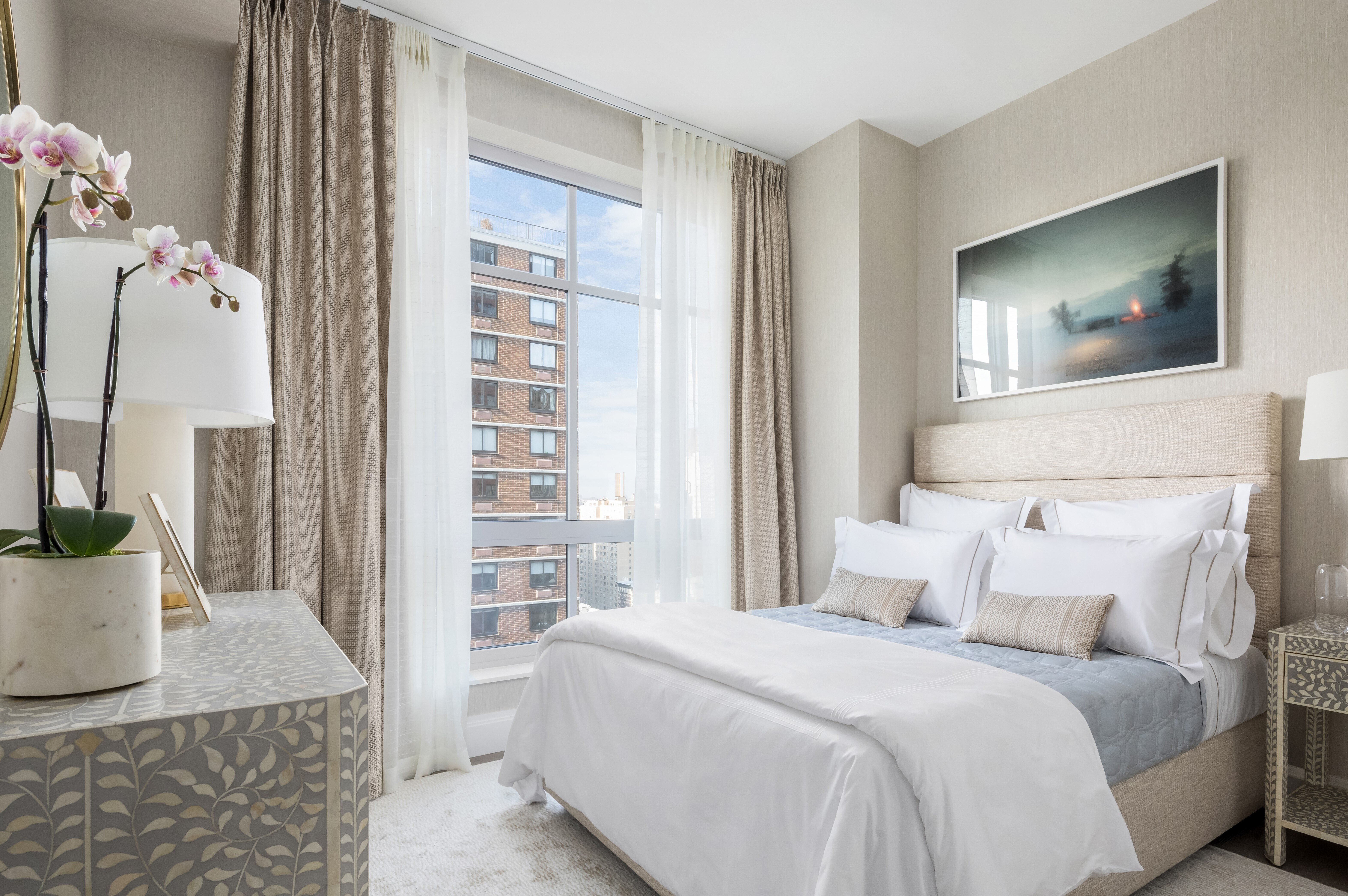 200 East 95th Street, Unit 15A Manhattan, NY 10128 - Photo 10 of 25 a bedroom with a bed and a couch