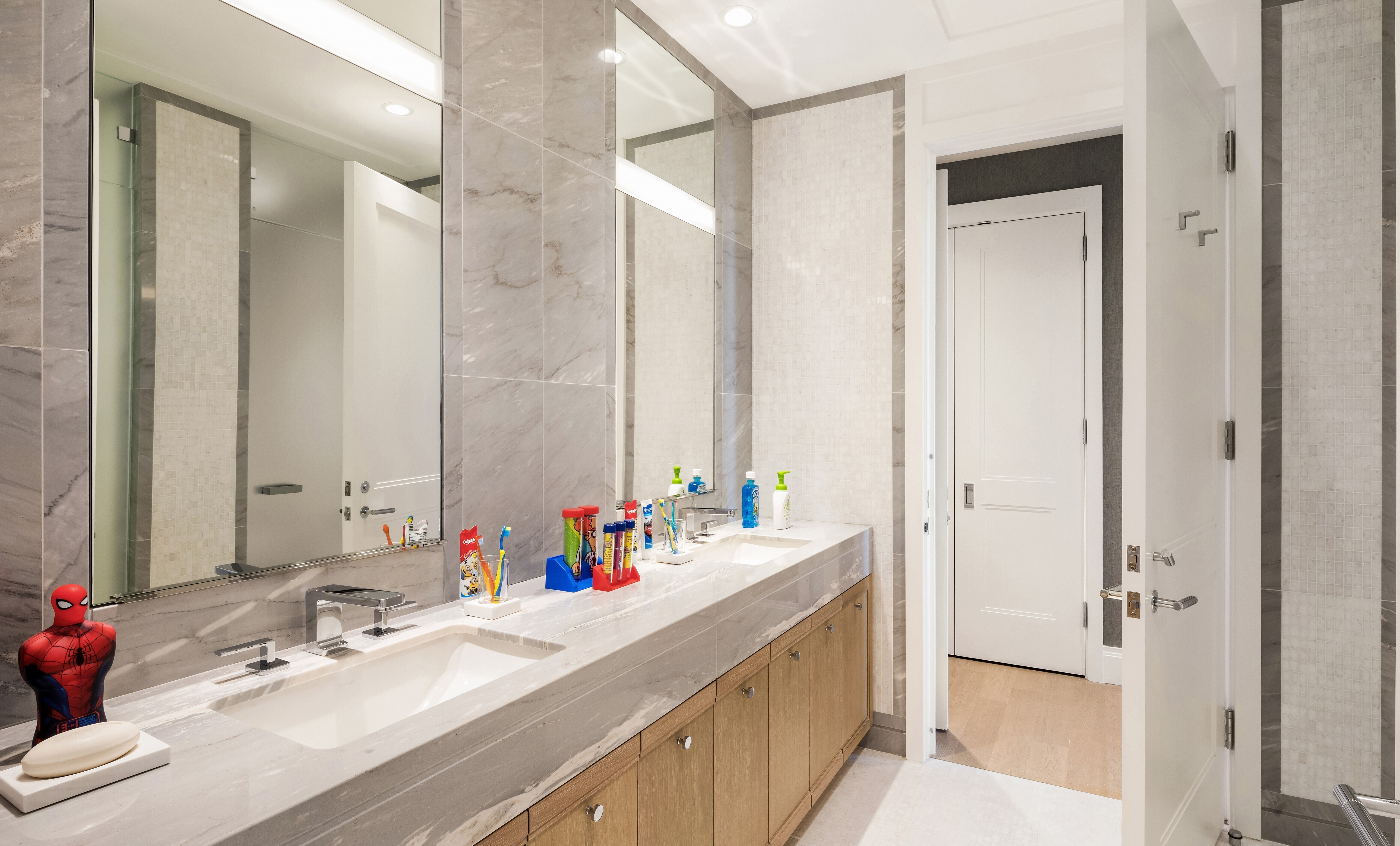 200 East 95th Street, Unit 15A Manhattan, NY 10128 - Photo 13 of 25 a bathroom with a double vanity sink mirror and double