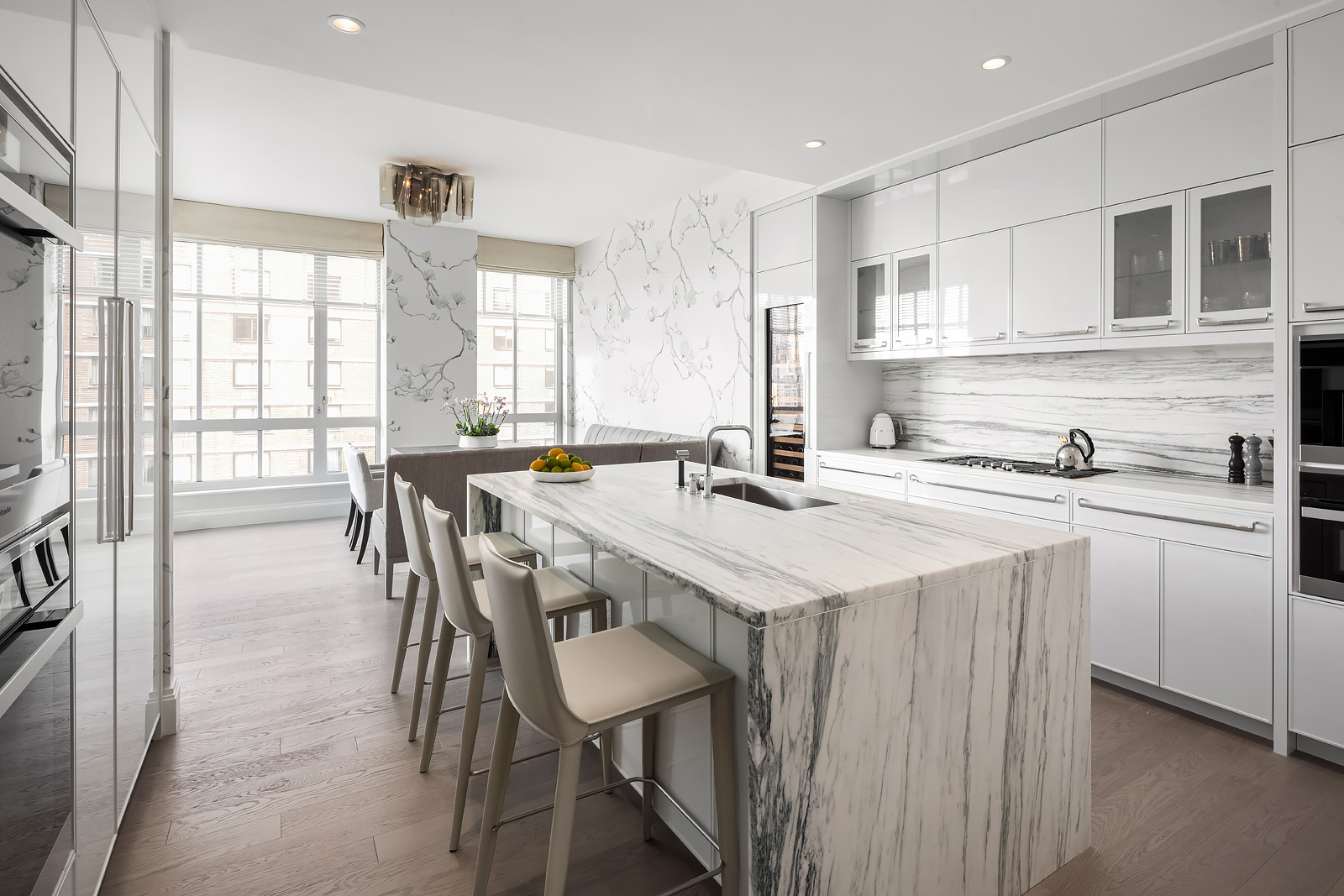 200 East 95th Street, Unit 15A Manhattan, NY 10128 - Photo 3 of 25 a kitchen with a table chairs stove and cabinets
