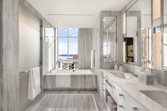 a spacious bedroom with a bed and glass window