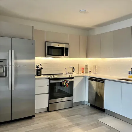 a kitchen with stainless steel appliances and granite countertop