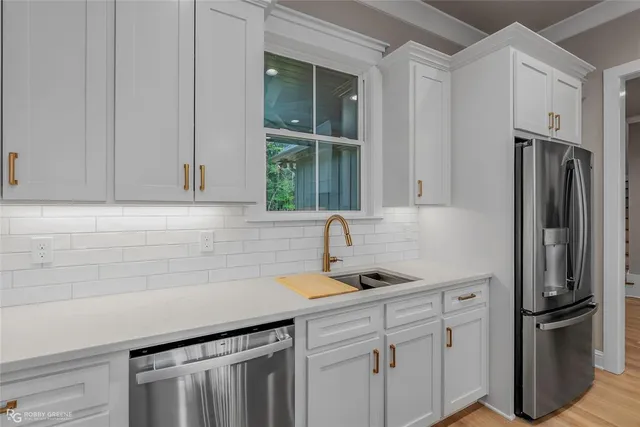 a kitchen with stainless steel appliances a sink stove and refrigerator