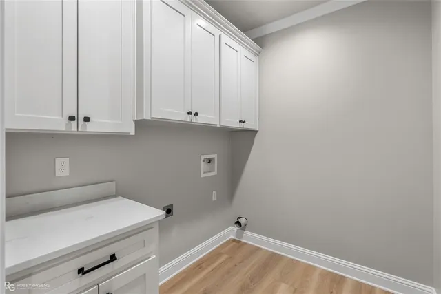 a view of storage and utility room with wooden floor