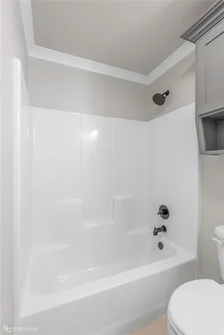 a bathroom with a bathtub and a toilet